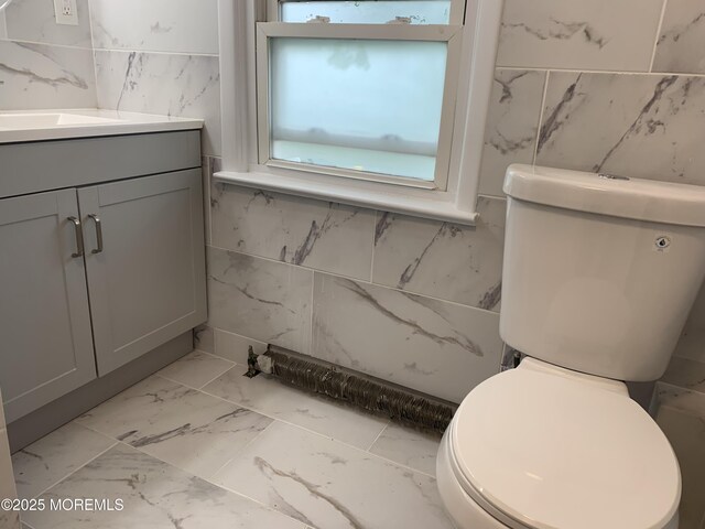 219 Hyers St, Toms River, NJ 08753 - bathroom featuring marble finish flooring, toilet, vanity, and tile walls