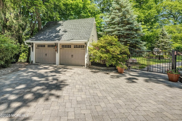1 Beechwood Ter, Matawan, NJ 07747 - garage featuring decorative driveway and view of scattered trees