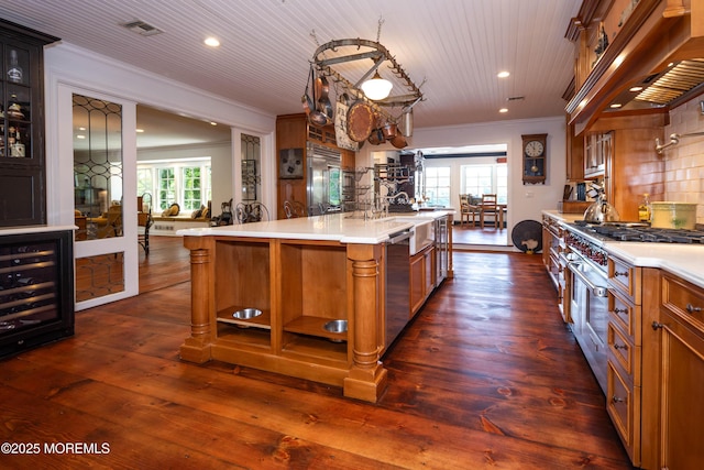 1 Beechwood Ter, Matawan, NJ 07747 - kitchen with wine cooler, light countertops, recessed lighting, ornamental molding, and a sink