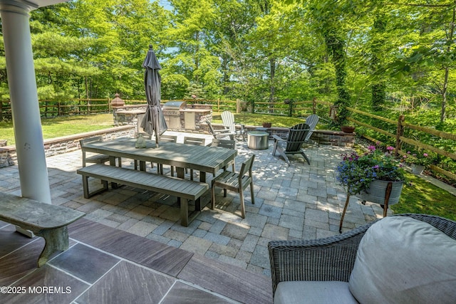 1 Beechwood Ter, Matawan, NJ 07747 - fenced backyard featuring outdoor dining space, a patio area, an outdoor kitchen, a fire pit, and view of scattered trees