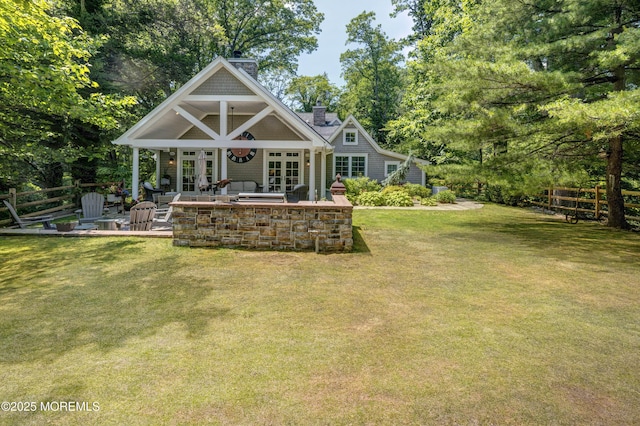 1 Beechwood Ter, Matawan, NJ 07747 - rear view of house with french doors, a patio, a chimney, and view of scattered trees