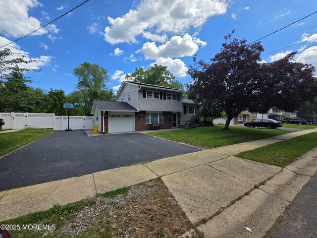 19 Fordham Rd, Jackson, NJ 08527 - view of front of home featuring a gate, brick siding, asphalt driveway, and a garage