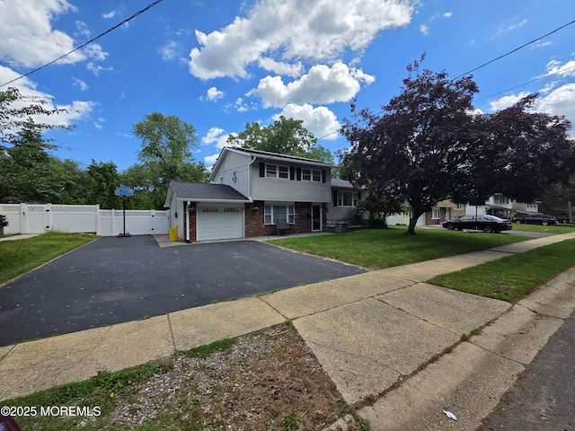19 Fordham Rd, Jackson, NJ 08527 - view of front facade featuring a gate, brick siding, driveway, and an attached garage