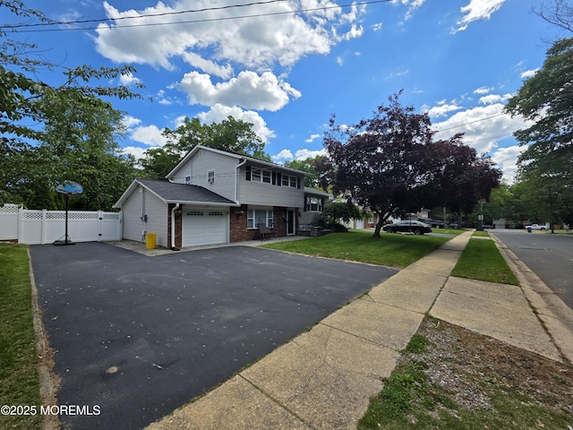 19 Fordham Rd, Jackson, NJ 08527 - view of front facade with driveway, brick siding, a garage, and a gate