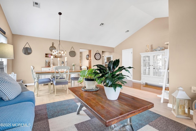 1 Sophia Ct, Toms River, NJ 08757 - living room featuring a chandelier, baseboards, high vaulted ceiling, and light wood finished floors