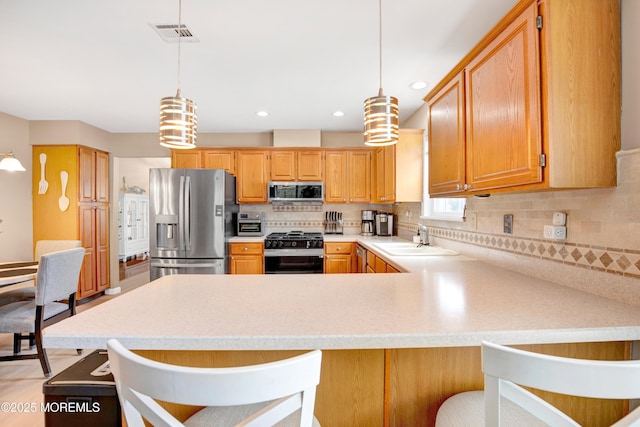 1 Sophia Ct, Toms River, NJ 08757 - kitchen with stainless steel appliances, a sink, light countertops, backsplash, and a peninsula
