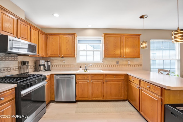 1 Sophia Ct, Toms River, NJ 08757 - kitchen with stainless steel appliances, a sink, a peninsula, light countertops, and tasteful backsplash
