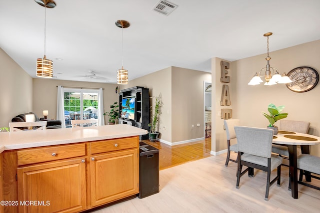 1 Sophia Ct, Toms River, NJ 08757 - kitchen featuring light wood-style flooring, light countertops, a chandelier, and decorative light fixtures