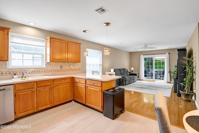 1 Sophia Ct, Toms River, NJ 08757 - kitchen with dishwasher, a sink, light wood-type flooring, a peninsula, and light countertops