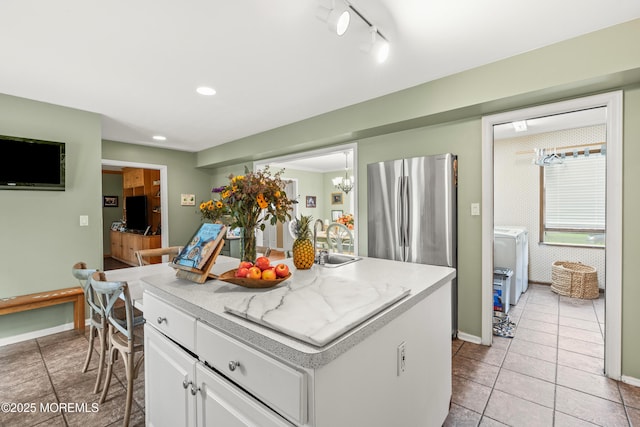 3404 Sandpiper Way, Allenwood, NJ 08720 - kitchen featuring freestanding refrigerator, white cabinets, light tile patterned floors, a kitchen island, and light countertops