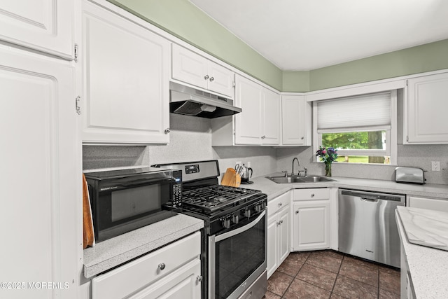 3404 Sandpiper Way, Allenwood, NJ 08720 - kitchen with stainless steel appliances, under cabinet range hood, a sink, white cabinetry, and light countertops