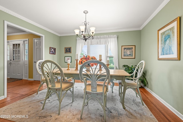 3404 Sandpiper Way, Allenwood, NJ 08720 - dining space featuring wood finished floors, a chandelier, baseboards, and crown molding