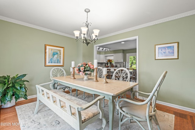 3404 Sandpiper Way, Allenwood, NJ 08720 - dining room featuring a chandelier, ornamental molding, baseboards, and light wood-style floors