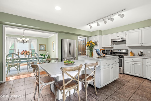 3404 Sandpiper Way, Allenwood, NJ 08720 - kitchen with appliances with stainless steel finishes, a center island, under cabinet range hood, white cabinets, and crown molding