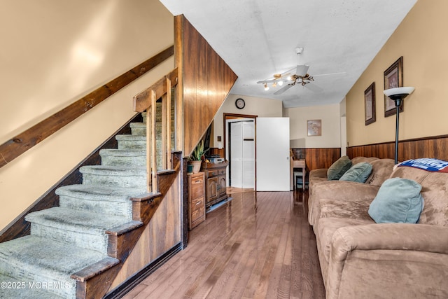 2419 Mallow St, Point Pleasant, NJ 08742 - living room featuring wainscoting, wood-type flooring, stairs, wooden walls, and a ceiling fan