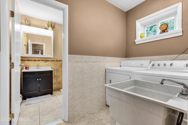2419 Mallow St, Point Pleasant, NJ 08742 - laundry area with tile walls, washer and dryer, and a wainscoted wall