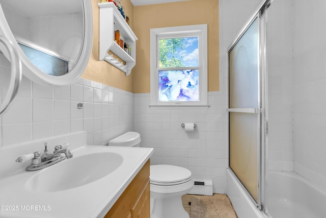 2419 Mallow St, Point Pleasant, NJ 08742 - full bath featuring tile walls, a baseboard radiator, vanity, toilet, and bath / shower combo with glass door