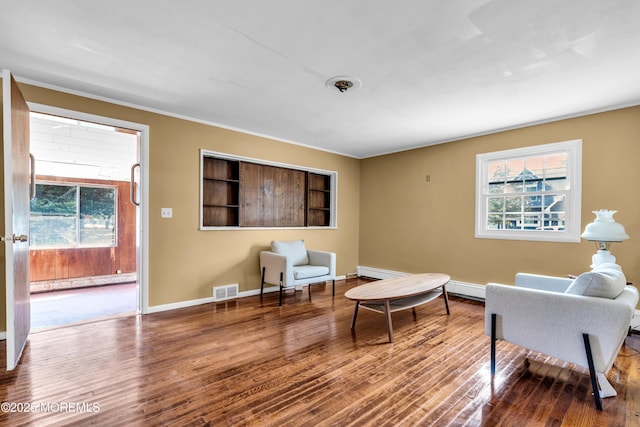 2419 Mallow St, Point Pleasant, NJ 08742 - living area with plenty of natural light, wood finished floors, baseboards, a baseboard radiator, and crown molding