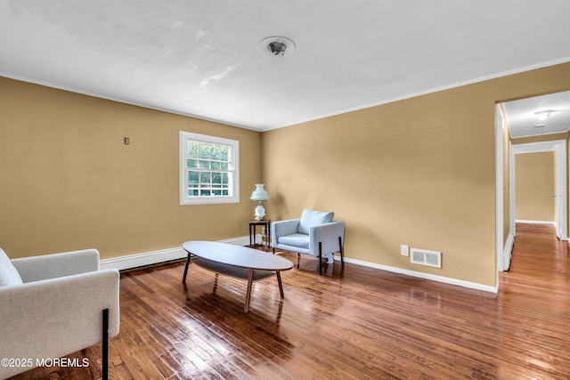 2419 Mallow St, Point Pleasant, NJ 08742 - living area with a baseboard heating unit, wood finished floors, baseboards, and ornamental molding