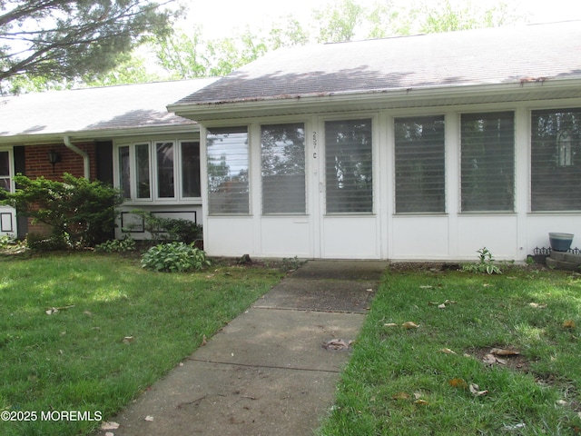257C Jefferson Ct, Lakewood, NJ 08701 - view of exterior entry featuring a lawn and a shingled roof