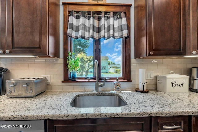 27 Barkalow Ave, Freehold, NJ 07728 - kitchen featuring a sink, dark brown cabinetry, light stone countertops, and decorative backsplash