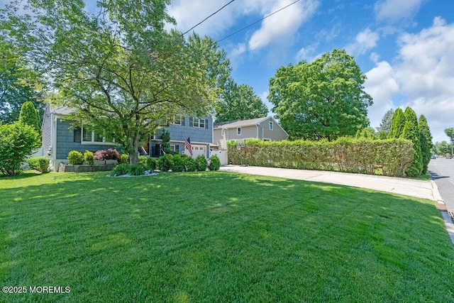 27 Barkalow Ave, Freehold, NJ 07728 - view of grassy yard featuring a garage and concrete driveway