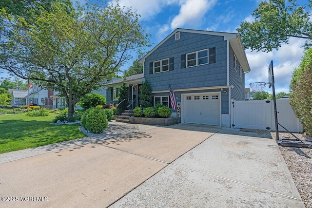 27 Barkalow Ave, Freehold, NJ 07728 - tri-level home with a gate, driveway, and a garage