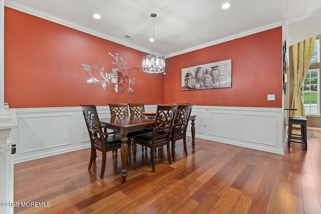 2420 Canterbury Ln, North Brunswick, NJ 08902 - dining room featuring wood finished floors, crown molding, recessed lighting, a chandelier, and wainscoting