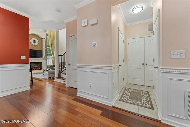 2420 Canterbury Ln, North Brunswick, NJ 08902 - entryway with ornamental molding, stairs, wainscoting, hardwood / wood-style floors, and a decorative wall