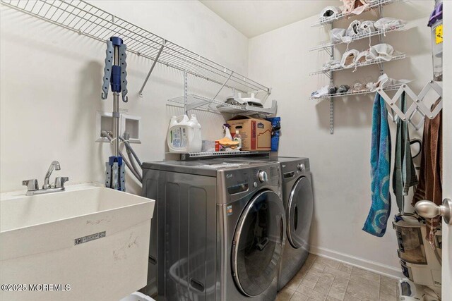 2420 Canterbury Ln, North Brunswick, NJ 08902 - laundry area featuring washer and clothes dryer and baseboards