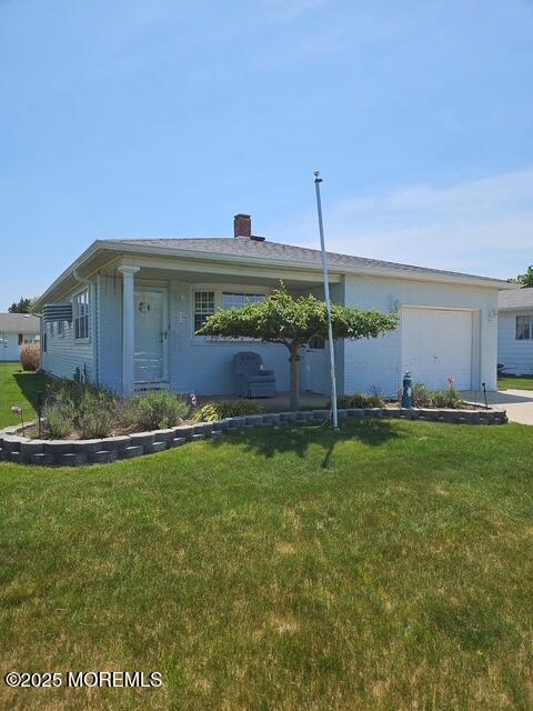 27 Maracaibo Pl, Toms River, NJ 08757 - view of front of home with a garage, a front yard, concrete driveway, and a chimney
