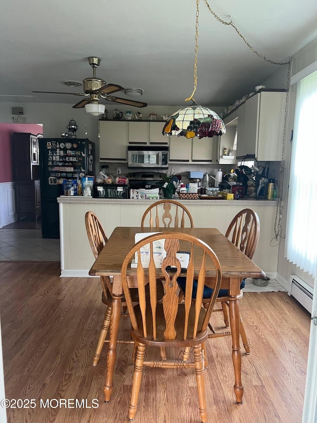 27 Maracaibo Pl, Toms River, NJ 08757 - dining space with a ceiling fan, wood finished floors, and a baseboard radiator