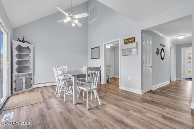 3 Drake Dr, Bayville, NJ 08721 - dining space featuring ceiling fan, light wood-style flooring, baseboards, baseboard heating, and high vaulted ceiling