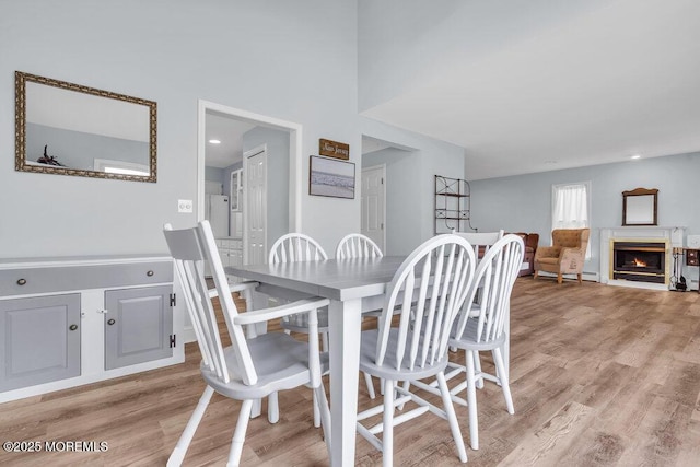 3 Drake Dr, Bayville, NJ 08721 - dining space with light wood-style flooring and a warm lit fireplace