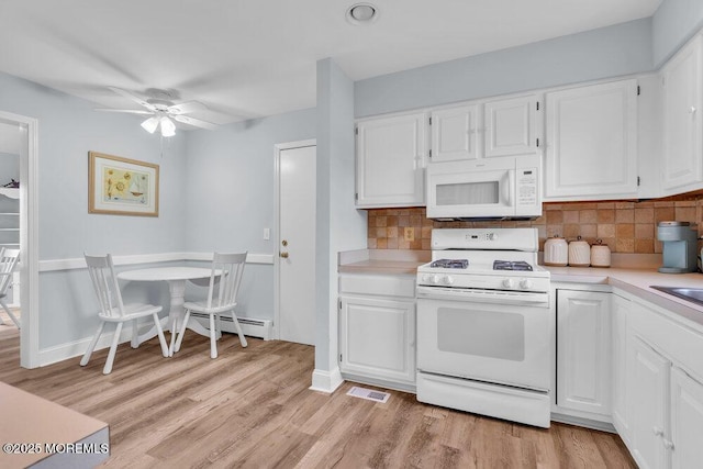 3 Drake Dr, Bayville, NJ 08721 - kitchen featuring white appliances, light countertops, light wood-style flooring, and white cabinets