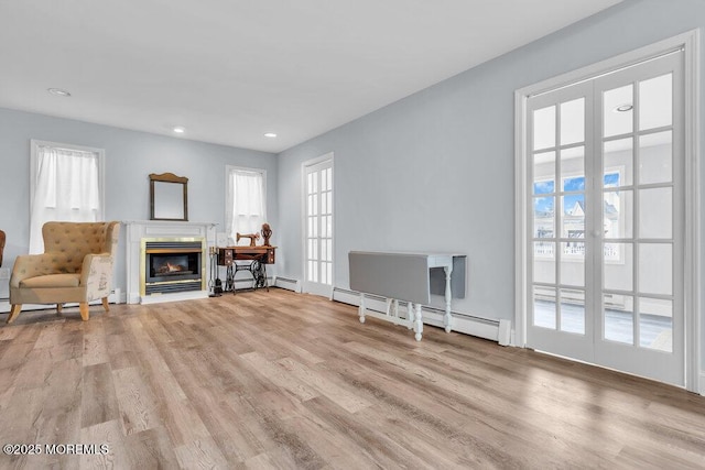 3 Drake Dr, Bayville, NJ 08721 - unfurnished living room with wood finished floors, healthy amount of natural light, baseboard heating, recessed lighting, and a glass covered fireplace
