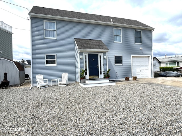 3 Drake Dr, Bayville, NJ 08721 - rear view of house with an attached garage, a storage shed, and driveway