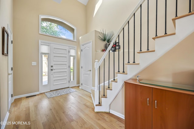 117 Sequoia Woods Ct, Holmdel, NJ 07733 - foyer featuring plenty of natural light, light wood-style flooring, a high ceiling, and stairs