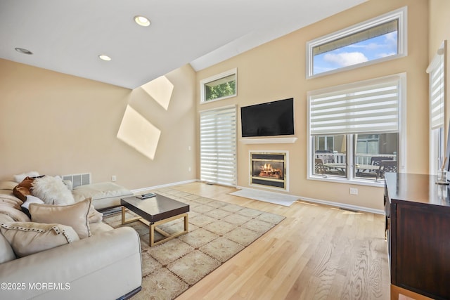 117 Sequoia Woods Ct, Holmdel, NJ 07733 - living area with wood finished floors, baseboards, a glass covered fireplace, and recessed lighting