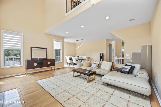 117 Sequoia Woods Ct, Holmdel, NJ 07733 - living room featuring wood finished floors, recessed lighting, a towering ceiling, and baseboards