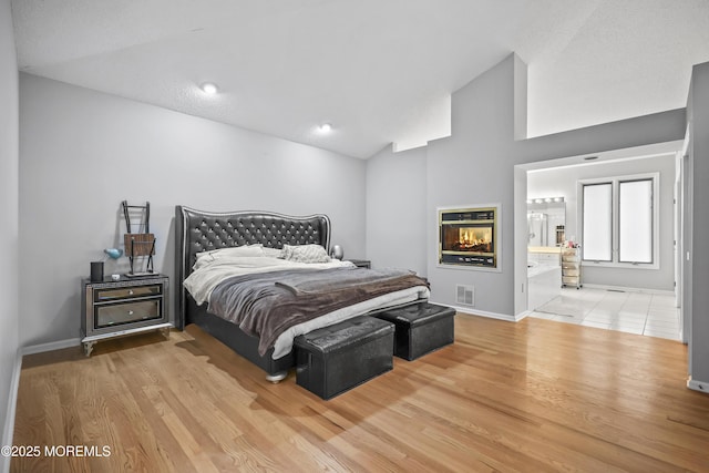 117 Sequoia Woods Ct, Holmdel, NJ 07733 - bedroom with lofted ceiling, wood finished floors, and baseboards