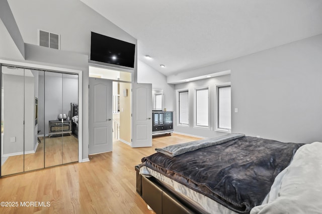 117 Sequoia Woods Ct, Holmdel, NJ 07733 - bedroom with light wood-style flooring, high vaulted ceiling, a closet, and baseboards