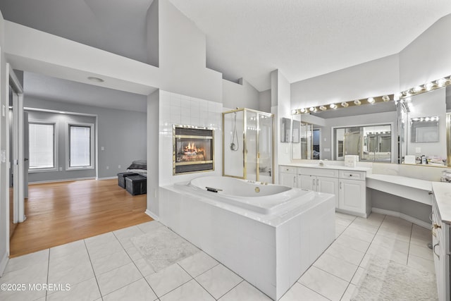 117 Sequoia Woods Ct, Holmdel, NJ 07733 - bathroom with tile patterned flooring, a stall shower, a garden tub, vanity, and lofted ceiling