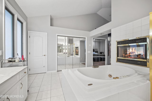 117 Sequoia Woods Ct, Holmdel, NJ 07733 - bathroom with a whirlpool tub, vanity, lofted ceiling, tile patterned flooring, and a multi sided fireplace