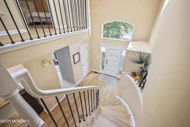117 Sequoia Woods Ct, Holmdel, NJ 07733 - entryway featuring a high ceiling, wood finished floors, stairs, and baseboards