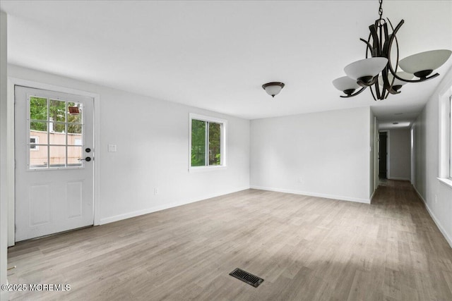 46 Roberts Rd, Toms River, NJ 08755 - unfurnished living room with wood finished floors, a chandelier, and baseboards