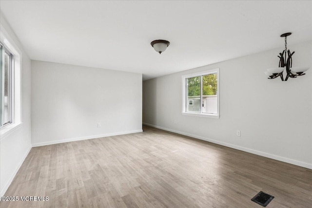 46 Roberts Rd, Toms River, NJ 08755 - empty room featuring wood finished floors, a chandelier, and baseboards
