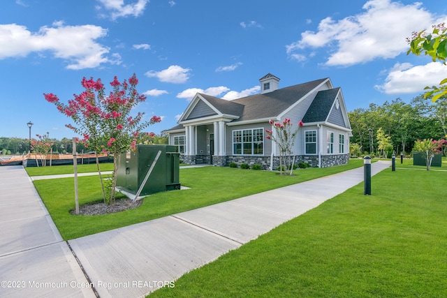 750 Lighthouse Dr Unit 1112, Barnegat, NJ 08005 - view of front facade featuring stone siding, a front yard, and a shingled roof