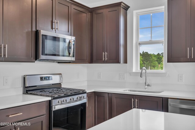 750 Lighthouse Dr Unit 1103, Barnegat, NJ 08005 - kitchen featuring stainless steel appliances, a sink, light countertops, and dark brown cabinetry