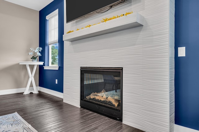 750 Lighthouse Dr Unit 3301, Barnegat, NJ 08005 - detailed view of wood finished floors, baseboards, and a glass covered fireplace